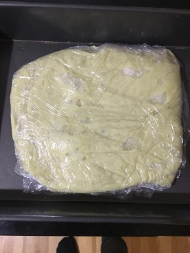 Cream covered in wrap, in shallow pan